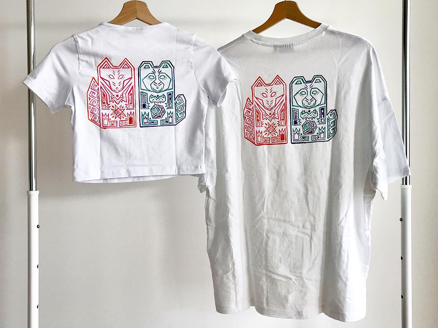 Handpainted tee-shirts. Motif is a totem representing a Tanuki (racoon dog) and a kitsune (fox).