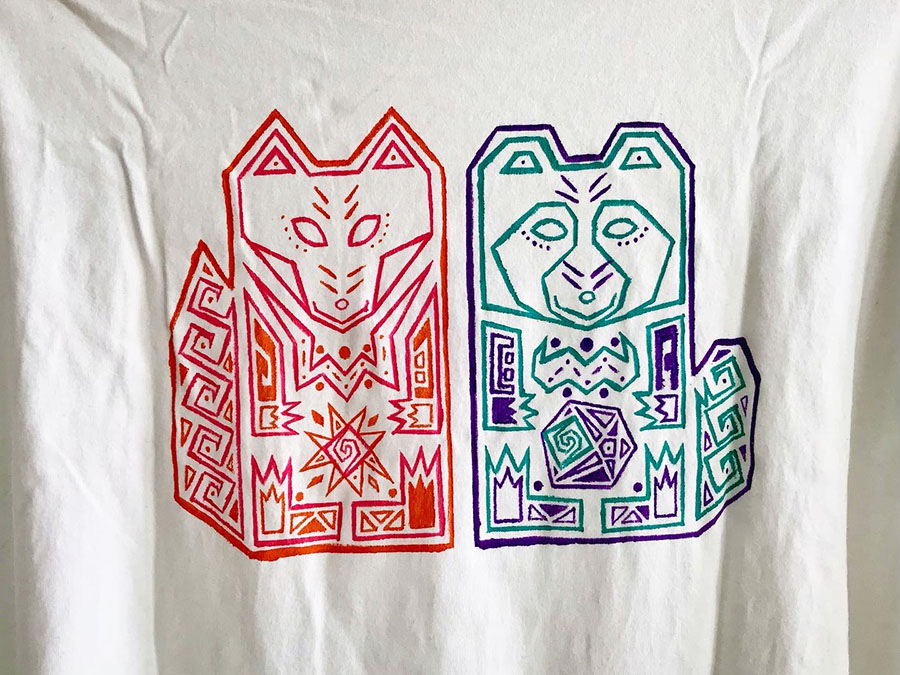 Handpainted tee-shirts. Motif is a totem representing a Tanuki (racoon dog) and a kitsune (fox).